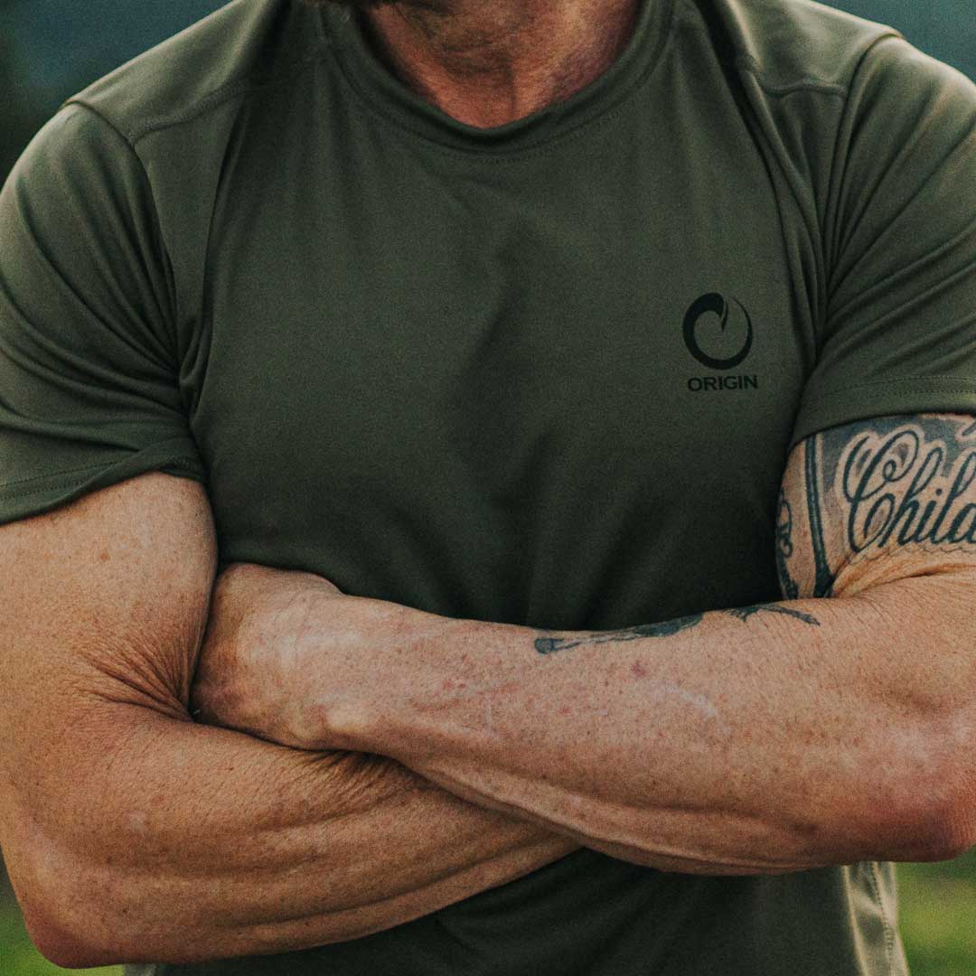 Man with crossed arms wearing Origin RTX Short Sleeve t-shirt